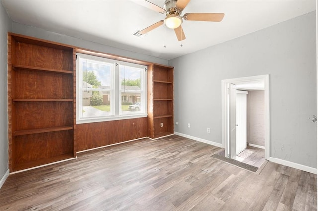 2545 W Eubanks St, Oklahoma City, OK 73112 - unfurnished bedroom featuring wood finished floors, baseboards, and a ceiling fan
