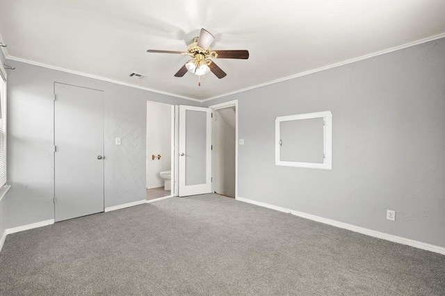 2545 W Eubanks St, Oklahoma City, OK 73112 - unfurnished bedroom with carpet, crown molding, baseboards, ensuite bath, and ceiling fan