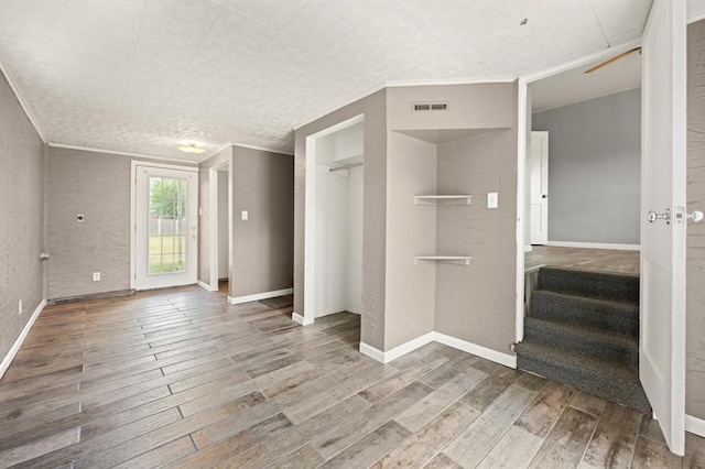 2545 W Eubanks St, Oklahoma City, OK 73112 - unfurnished bedroom featuring wood finished floors, ornamental molding, baseboards, access to outside, and a closet