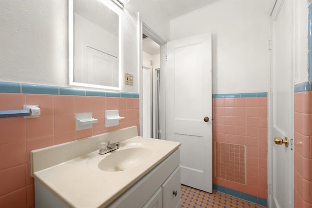 2545 W Eubanks St, Oklahoma City, OK 73112 - bathroom featuring tile walls, wainscoting, and vanity