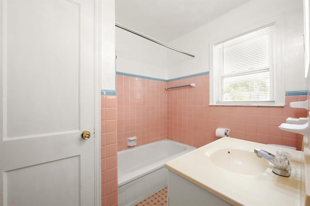 2545 W Eubanks St, Oklahoma City, OK 73112 - bathroom with tile walls, vanity, and washtub / shower combination