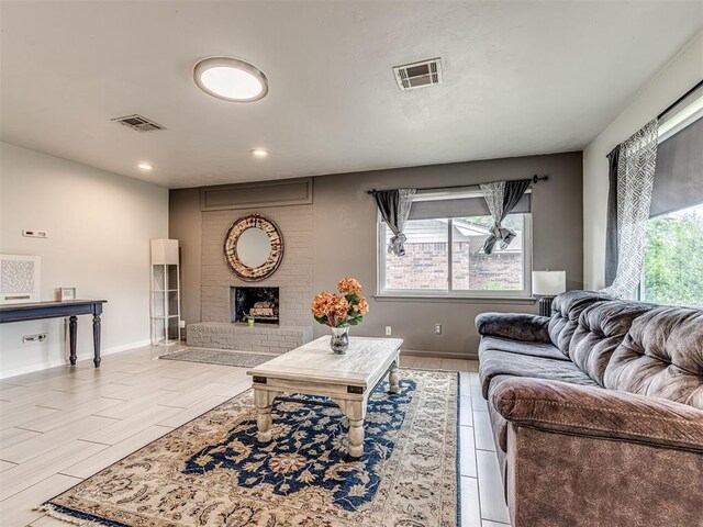 living room featuring recessed lighting, baseboards, and a fireplace