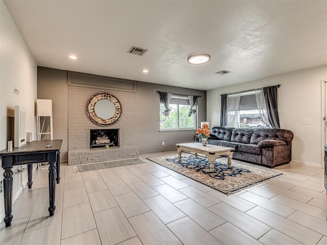 living area featuring a fireplace, baseboards, and recessed lighting