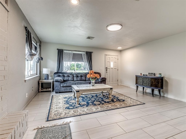 living area with plenty of natural light and baseboards