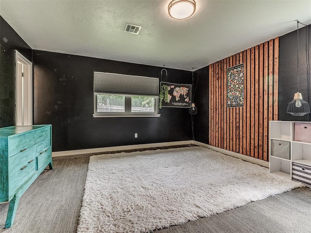 unfurnished bedroom featuring carpet floors, baseboards, and a textured ceiling
