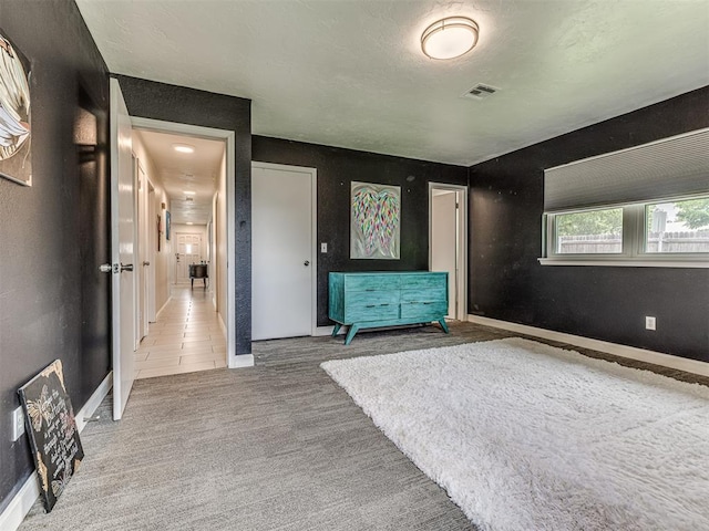 unfurnished bedroom with carpet and baseboards
