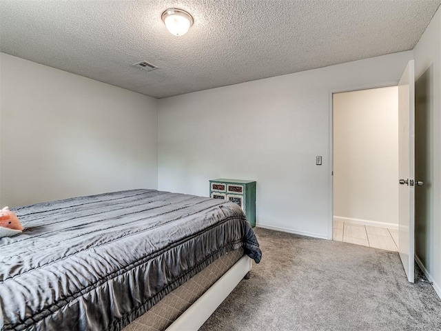bedroom featuring carpet floors, a textured ceiling, and baseboards