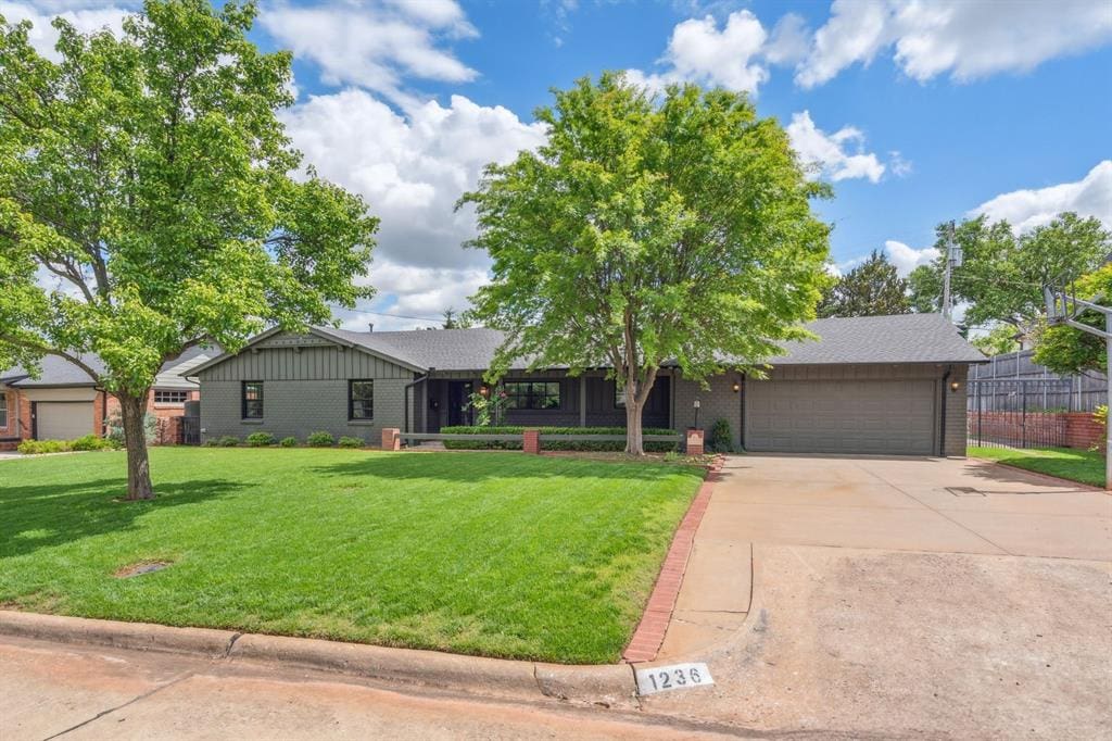 1236 Glenbrook Ter, Nichols Hills, OK 73116 - ranch-style house featuring a garage, driveway, and brick siding