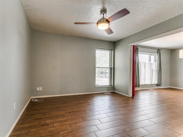 2916 Prairie Rose Ct, Oklahoma City, OK 73120 - unfurnished room with wood finished floors, ceiling fan, a textured ceiling, and baseboards