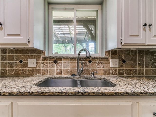 2916 Prairie Rose Ct, Oklahoma City, OK 73120 - kitchen view of a sink, white cabinets, stone counters, and tasteful backsplash
