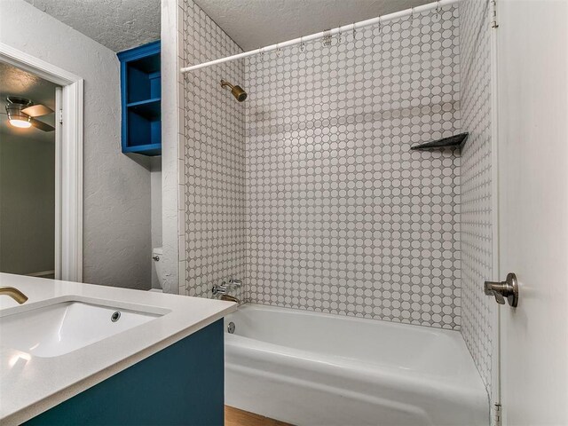 2916 Prairie Rose Ct, Oklahoma City, OK 73120 - bathroom featuring bathing tub / shower combination, a textured ceiling, a textured wall, and vanity