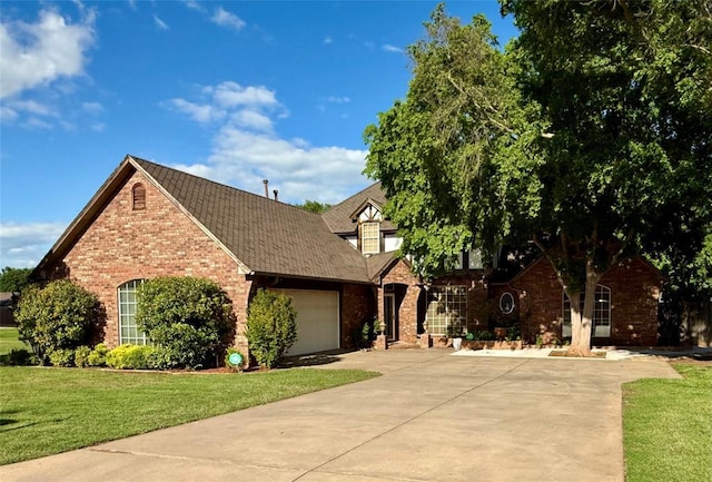view of front of property with brick siding, concrete driveway, a garage, a front yard, and roof with shingles