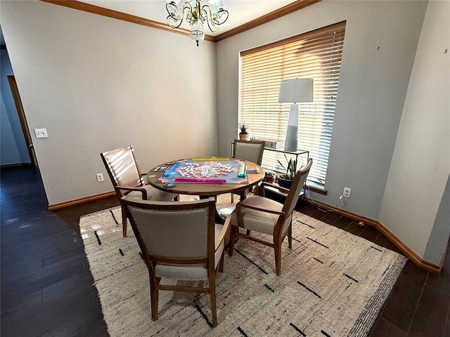 dining room featuring a chandelier, ornamental molding, plenty of natural light, wood finished floors, and baseboards