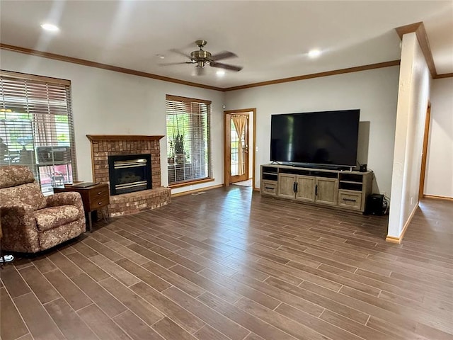 unfurnished living room with crown molding, ceiling fan, dark wood finished floors, a brick fireplace, and recessed lighting