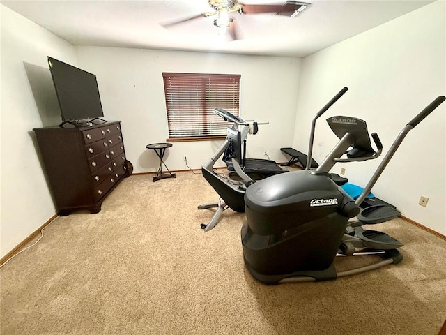 exercise area with ceiling fan, carpet, and baseboards