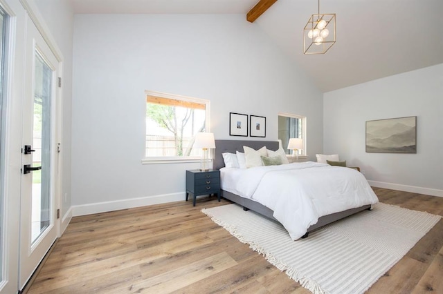 2101 NW 60th St, Oklahoma City, OK 73112 - bedroom featuring beam ceiling, high vaulted ceiling, a chandelier, light wood-style floors, and baseboards