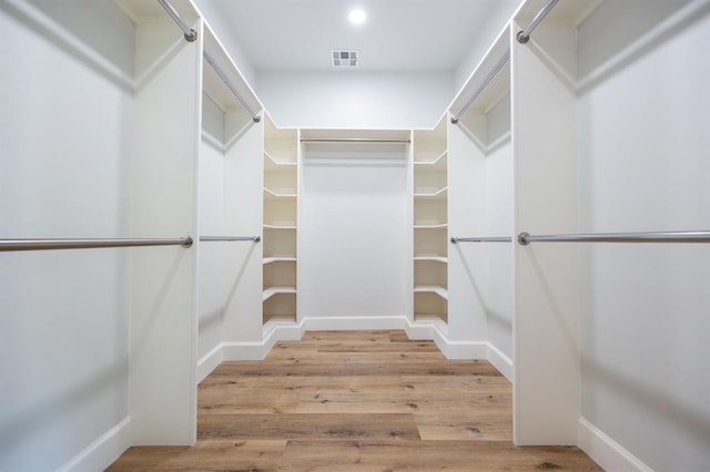 2101 NW 60th St, Oklahoma City, OK 73112 - walk in closet featuring wood finished floors