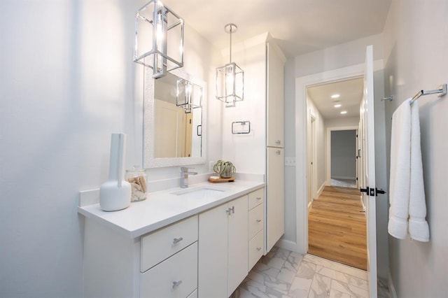 2101 NW 60th St, Oklahoma City, OK 73112 - bathroom with marble look tiles, vanity, and baseboards