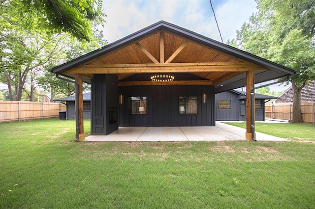 2101 NW 60th St, Oklahoma City, OK 73112 - rear view of house with board and batten siding, a patio area, and central air condition unit