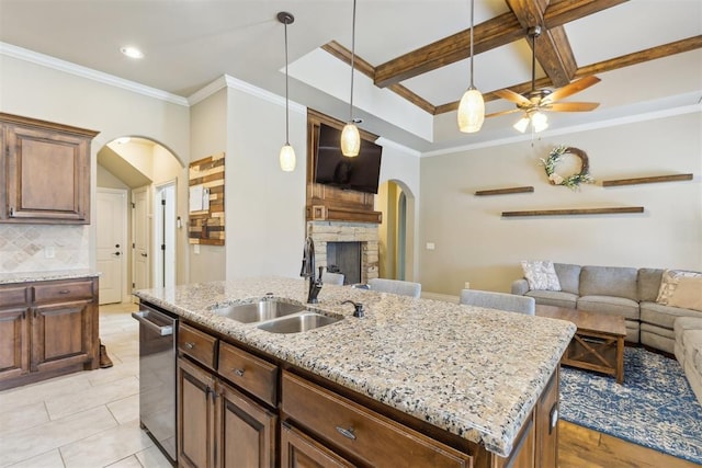 19724 Meadow Bend Ave, Edmond, OK 73012 - kitchen with arched walkways, a sink, stainless steel dishwasher, open floor plan, and a ceiling fan