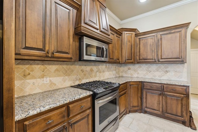 19724 Meadow Bend Ave, Edmond, OK 73012 - kitchen featuring stainless steel appliances, light stone countertops, crown molding, tasteful backsplash, and light tile patterned floors