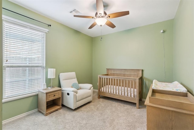 19724 Meadow Bend Ave, Edmond, OK 73012 - carpeted bedroom with a nursery area, baseboards, and a ceiling fan