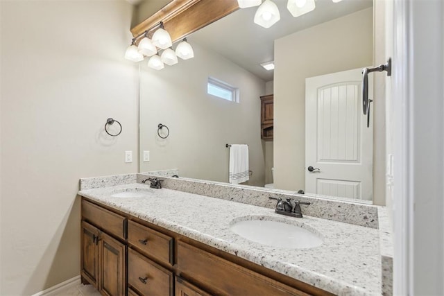 19724 Meadow Bend Ave, Edmond, OK 73012 - bathroom featuring toilet, double vanity, and baseboards