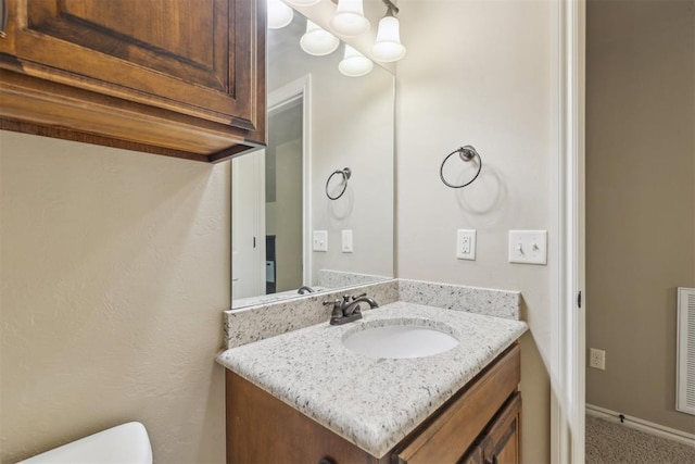 19724 Meadow Bend Ave, Edmond, OK 73012 - bathroom with vanity, toilet, and a chandelier