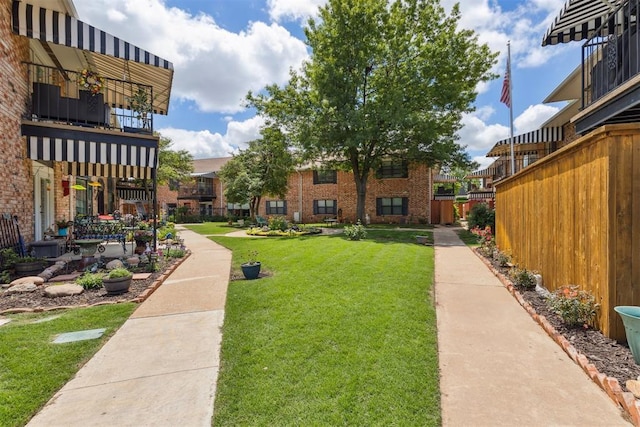 2525 NW 62nd St Unit 208, Oklahoma City, OK 73112 - view of green lawn featuring a balcony