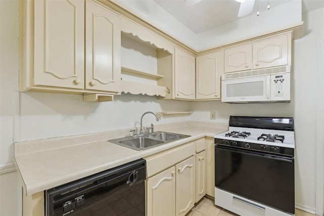 2525 NW 62nd St Unit 208, Oklahoma City, OK 73112 - kitchen featuring range with gas stovetop, white microwave, black dishwasher, a sink, and cream cabinetry