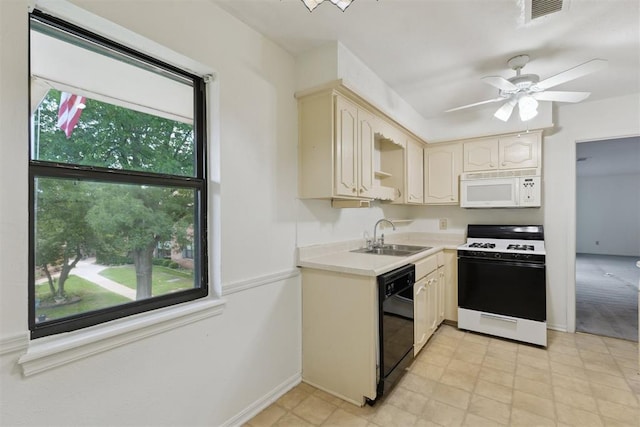 2525 NW 62nd St Unit 208, Oklahoma City, OK 73112 - kitchen with white appliances, a sink, light countertops, baseboards, and a ceiling fan