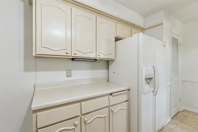2525 NW 62nd St Unit 208, Oklahoma City, OK 73112 - kitchen with white refrigerator with ice dispenser, light countertops, and cream cabinetry
