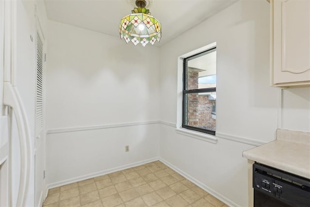 2525 NW 62nd St Unit 208, Oklahoma City, OK 73112 - unfurnished dining area featuring baseboards and light floors