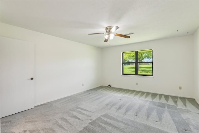 2525 NW 62nd St Unit 208, Oklahoma City, OK 73112 - spare room featuring light carpet, ceiling fan, and baseboards