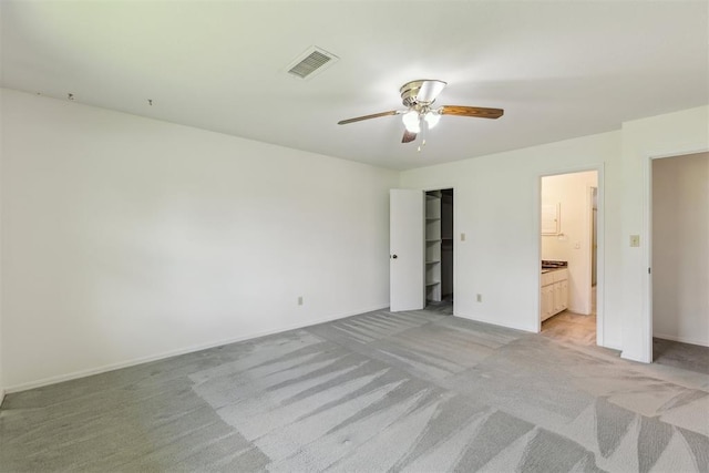 2525 NW 62nd St Unit 208, Oklahoma City, OK 73112 - unfurnished bedroom with light colored carpet, ensuite bath, baseboards, a closet, and ceiling fan