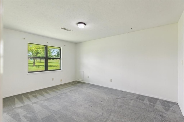 2525 NW 62nd St Unit 208, Oklahoma City, OK 73112 - carpeted spare room featuring baseboards and a textured ceiling