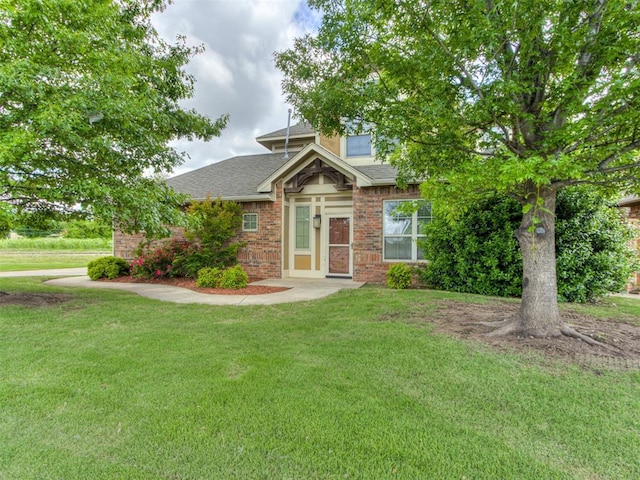 1701 NE 7th St, Oklahoma City, OK 73117 - view of front of house featuring a front lawn, brick siding, and a shingled roof