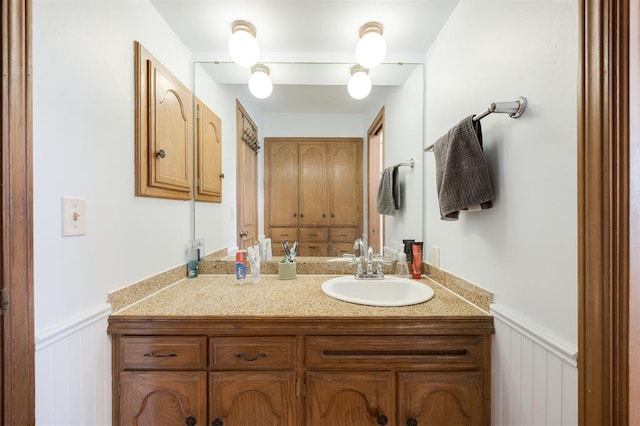 9801 Lancet Ln, Oklahoma City, OK 73120 - bathroom with vanity, a wainscoted wall, and a decorative wall