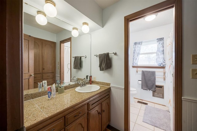 9801 Lancet Ln, Oklahoma City, OK 73120 - bathroom with wainscoting, vanity, and tile patterned floors