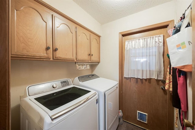 9801 Lancet Ln, Oklahoma City, OK 73120 - laundry area featuring washing machine and dryer, cabinet space, and a textured ceiling