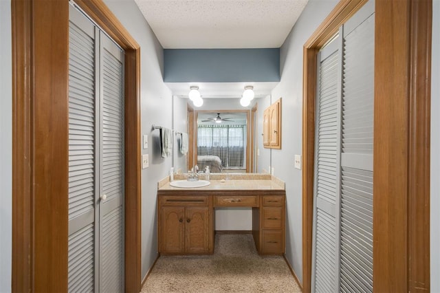 9801 Lancet Ln, Oklahoma City, OK 73120 - ensuite bathroom with a closet, vanity, ceiling fan, and a textured ceiling