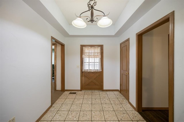 9801 Lancet Ln, Oklahoma City, OK 73120 - doorway to outside with a chandelier and a tray ceiling