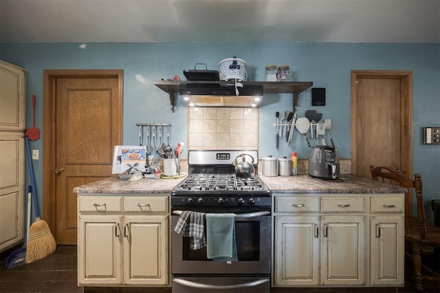 9801 Lancet Ln, Oklahoma City, OK 73120 - kitchen featuring stainless steel gas stove, ventilation hood, cream cabinets, and tasteful backsplash