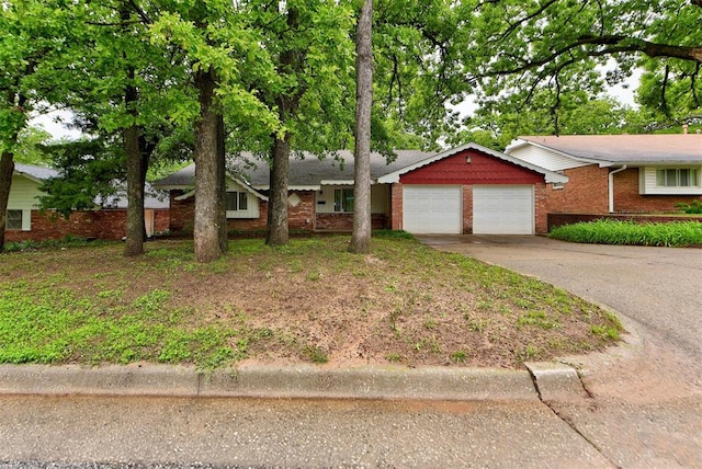 ranch-style home featuring a garage, brick siding, and concrete driveway