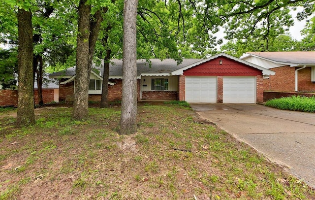 ranch-style home featuring a garage, brick siding, and driveway
