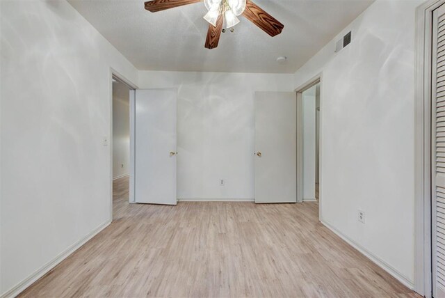 unfurnished bedroom with wood finished floors, baseboards, and ceiling fan