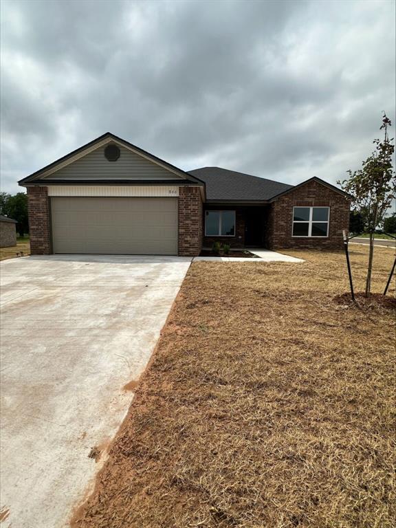 866 SW 11th St, Newcastle, OK 73065 - view of front of property featuring an attached garage, concrete driveway, and brick siding