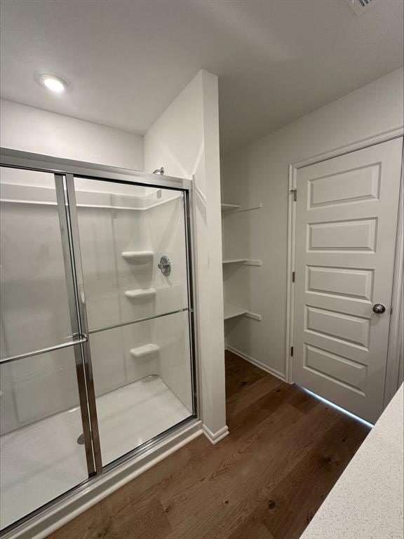 866 SW 11th St, Newcastle, OK 73065 - bathroom with wood finished floors, a stall shower, and baseboards