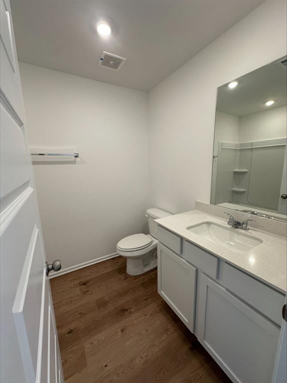 866 SW 11th St, Newcastle, OK 73065 - full bathroom with vanity, wood finished floors, toilet, a shower, and baseboards