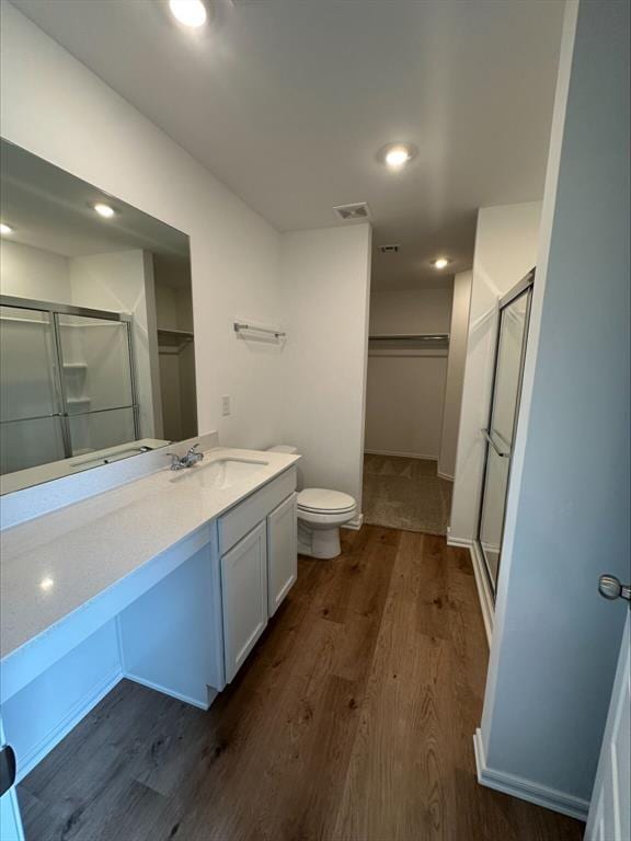 866 SW 11th St, Newcastle, OK 73065 - bathroom with a stall shower, vanity, wood finished floors, toilet, and recessed lighting